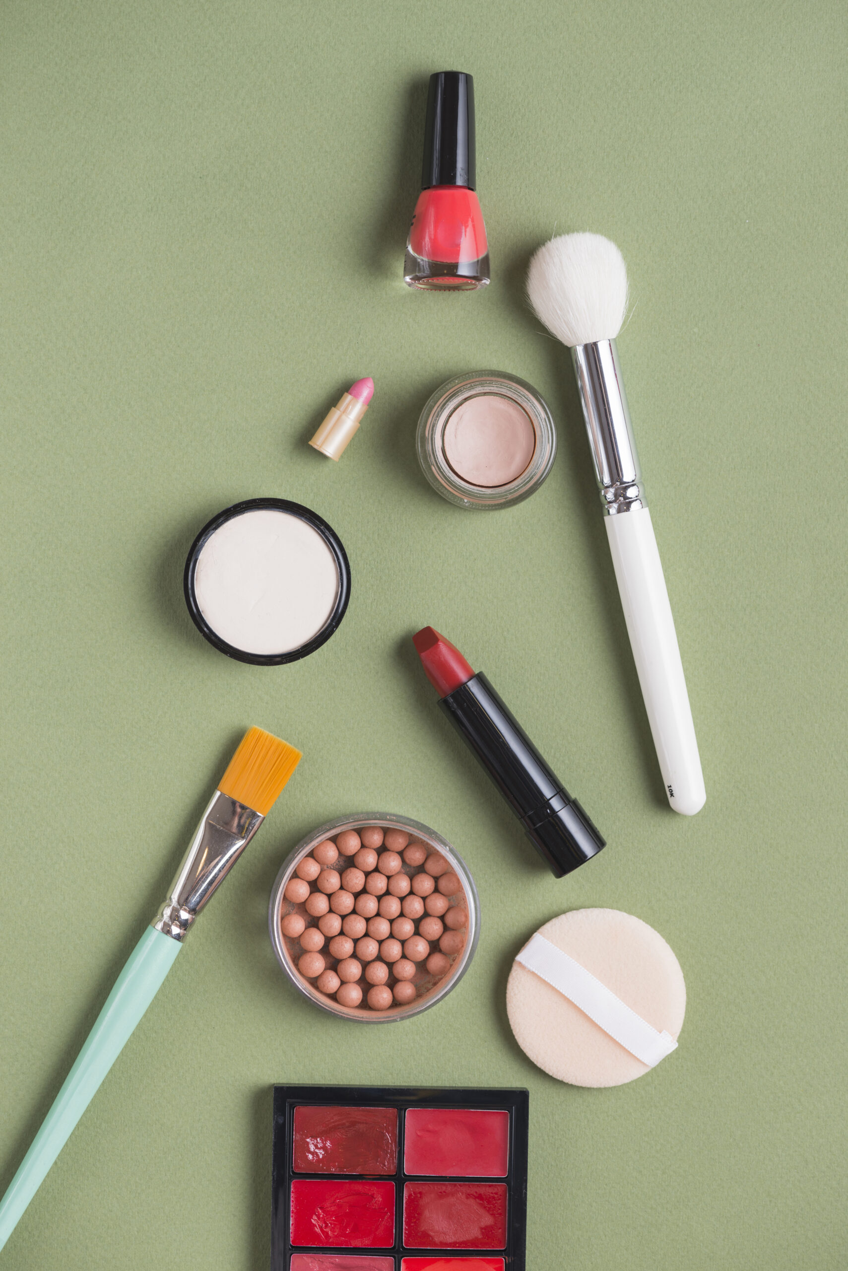 high-angle-view-various-makeup-products-green-background VARKO BEYOND - الصورة 1